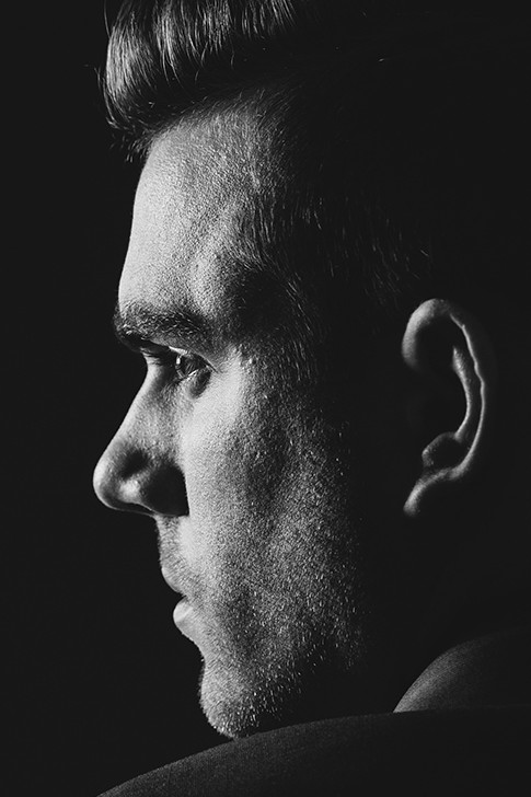 black and white close up of a man looking away from the camera